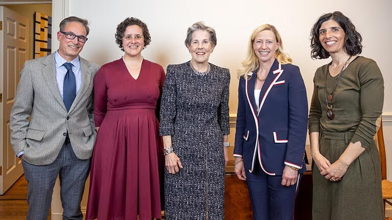 five people smile for a photo during an award ceremony