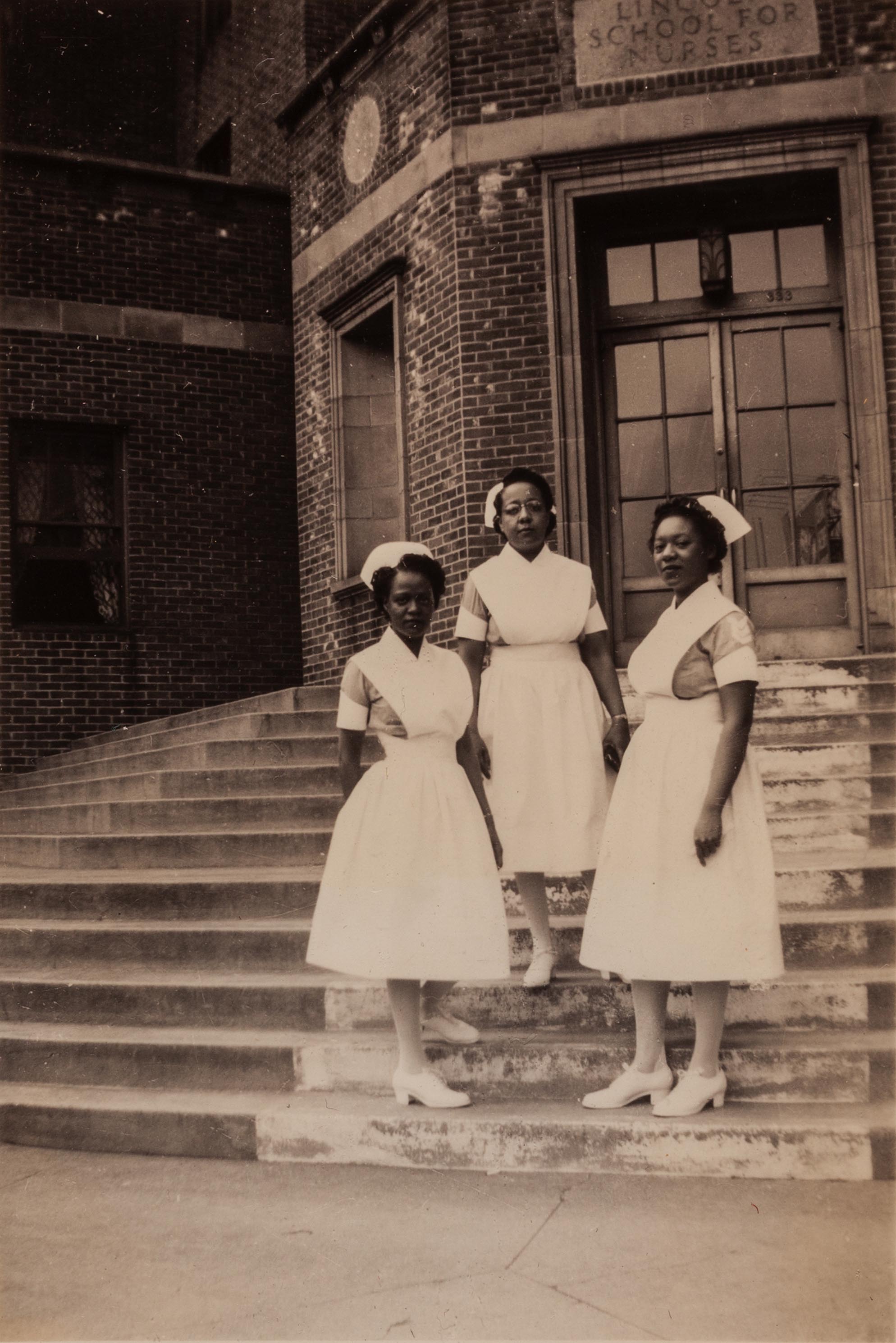 Three nurses on the steps of the Lincoln School for Nurses, Bronx, New York, gelatin silver print, circa 1930
