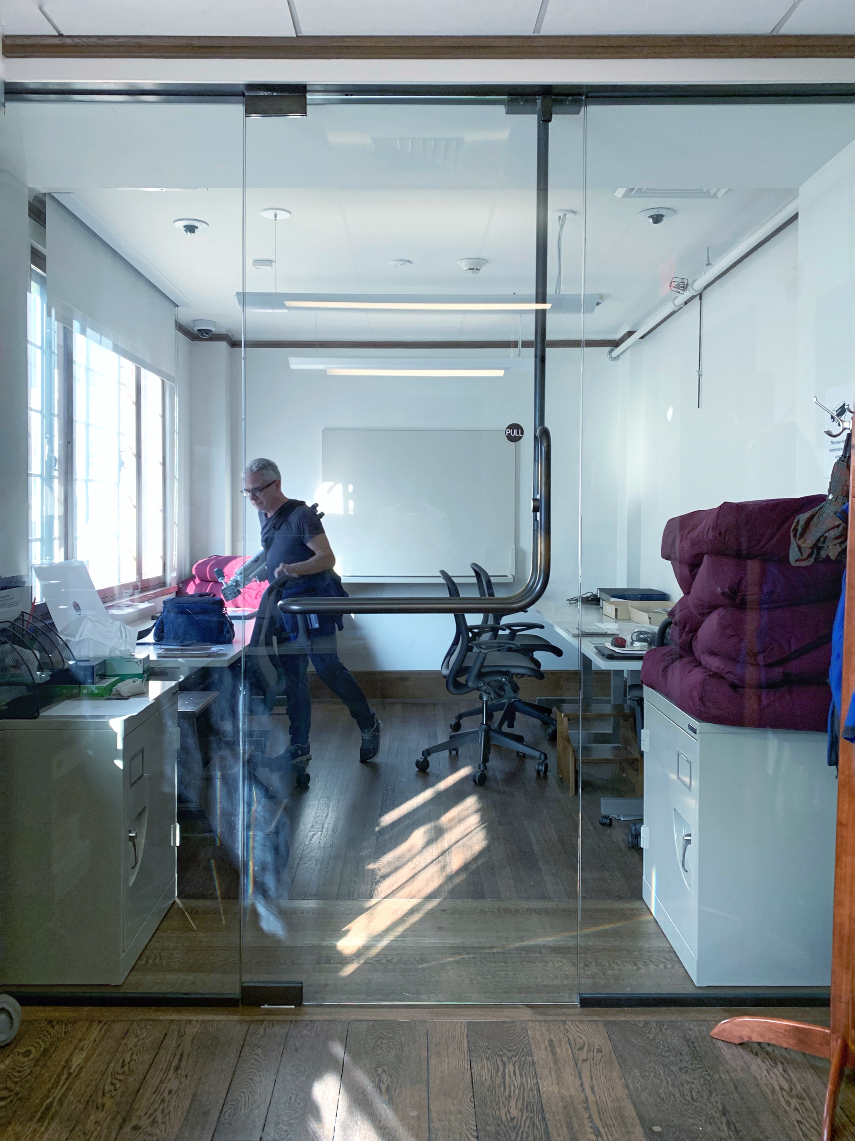 a man standing in a glass studio