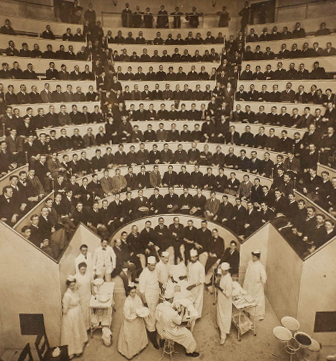 sepia toned photo from 1902 of a full surgical amphitheater during a procedure