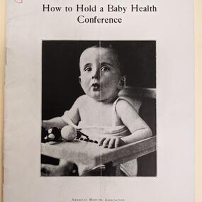 image of a book page titled how to hold a baby health conference with a black and white picture of a white baby in a high chair