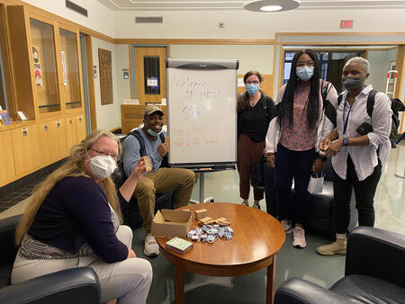 New MPH students pose for the camera in the medical library's entryway 