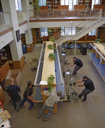 Movers relocate furniture in the Morse Reading Room.