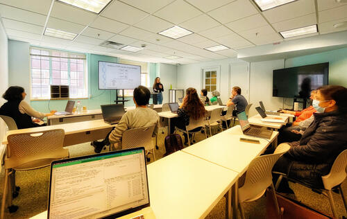 A peer-to-peer training session in the medical library's instruction classroom