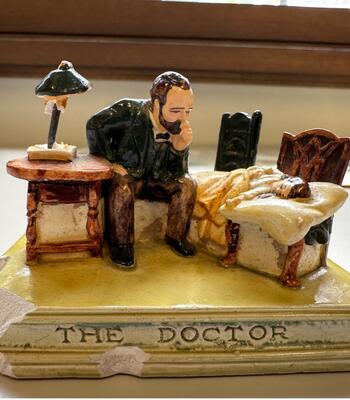 ceramic statue depicting a doctor and patient