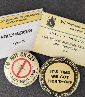 two ID badges with the name polly murray - lyme ct, and two pins that say 'I'm not crazy I just have Lyme' and 'It's time we got tick'd-off'