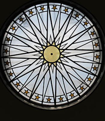 cushing rotunda ceiling displaying a starburst and stars around the edge