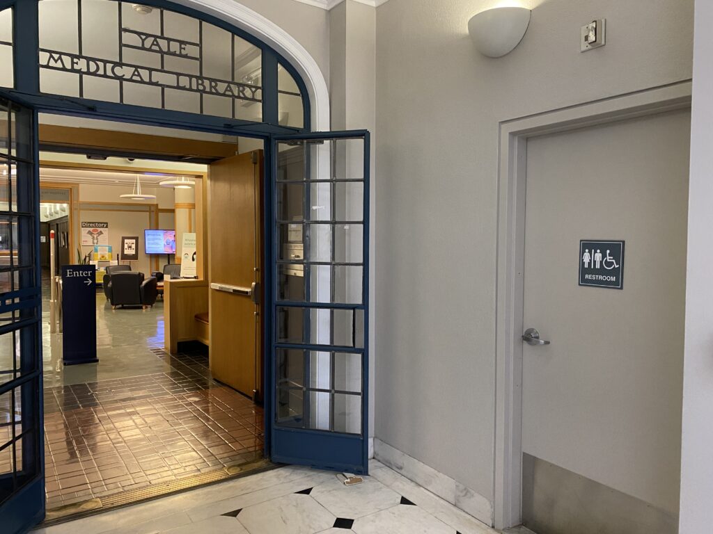 entrance to the medical library next to a wheelchair accessible bathroom